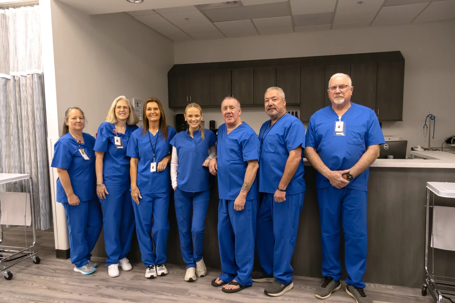 Jeffrey G. Tauth, M.D., F.A.C.C. with his care team in scrubs